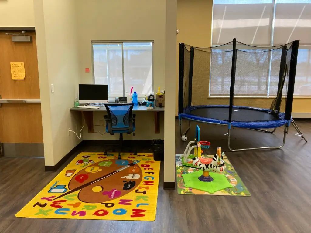 a-child's-room-with-a-play-mat-and-a-chair