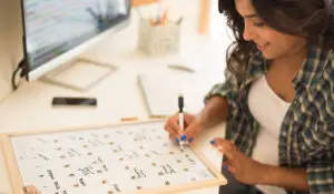 a woman writing a calendar plan on the desk